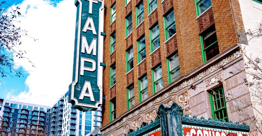 Vertical shot of downtown Tampa Theatre with distinct signage and urban architecture.