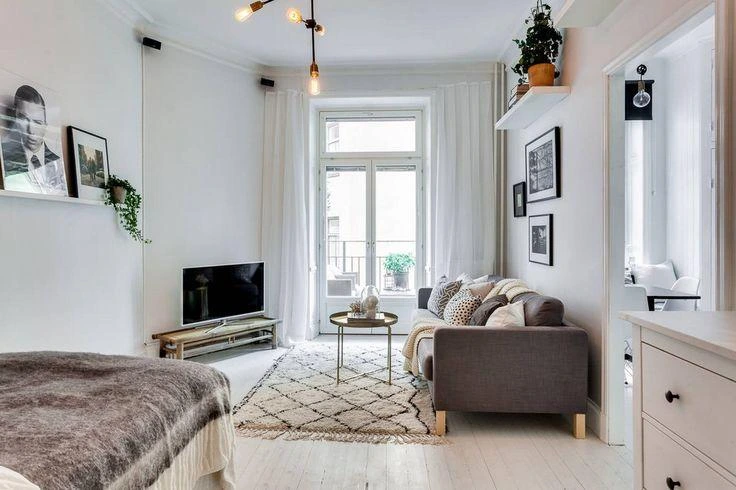 Cozy minimalist apartment living room with warm neutral decor and modern Scandinavian styling