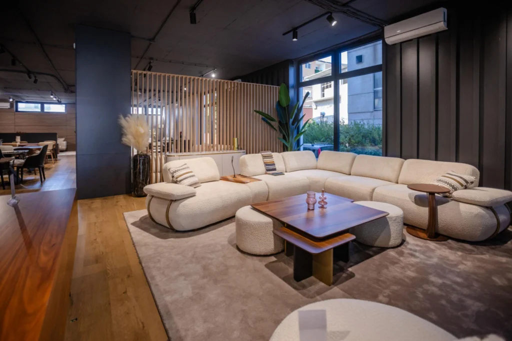 Modern beige sectional sofa in a small contemporary living room with warm neutral interior styling