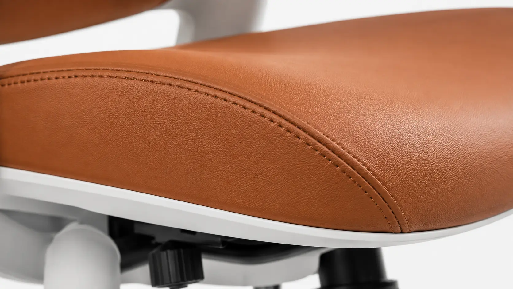 Close-up of stitched seam on PU leather office chair upholstery