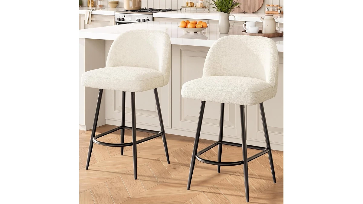 Two Garvee cream boucle counter stools with curved backs and black metal legs at a kitchen island